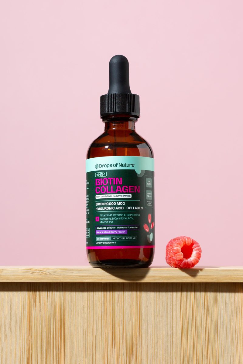 A bottle of Biotin Collagen on a shelf beside fresh raspberries.