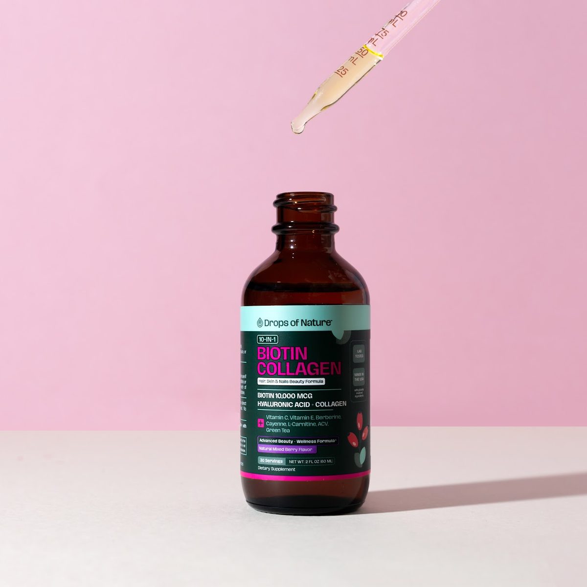 A dropper of Biotin Collagen drops over the open bottle.