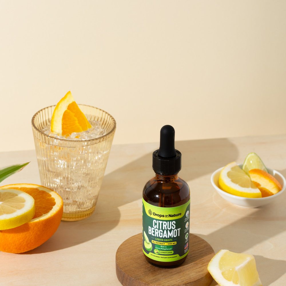 Citrus Bergamot bottle beside a glass of iced citrus water.