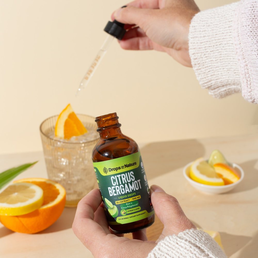 A dropper of Citrus Bergamot over a glass of water.
