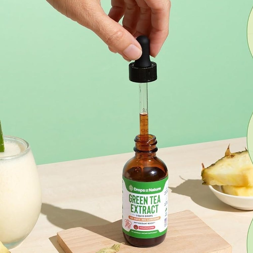 A dropper of Green Tea Extract over the bottle.