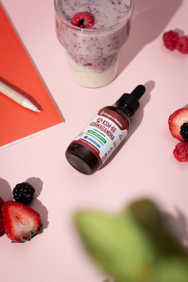 A bottle of KSM-66 Ashwagandha drops with fresh strawberries.