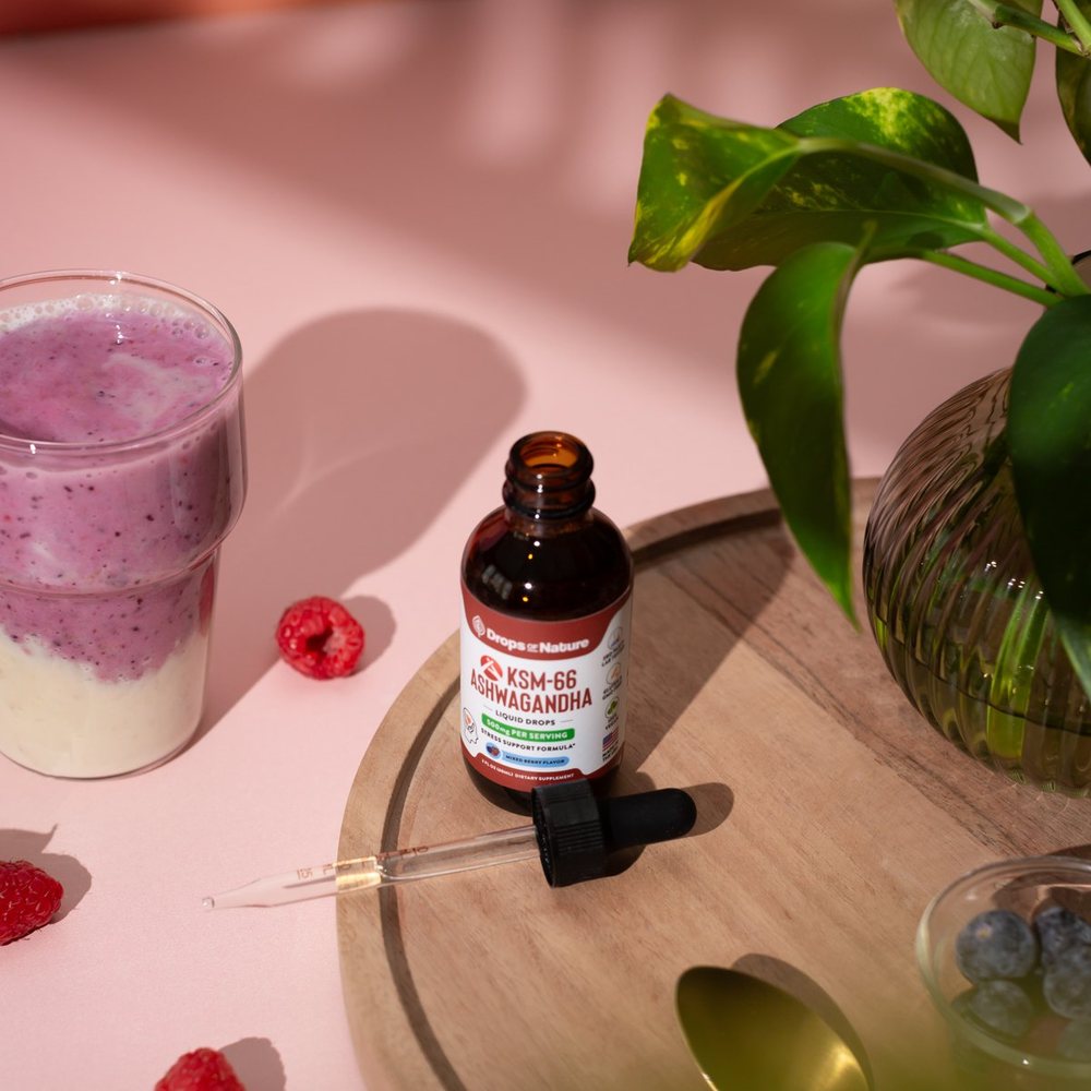 KSM-66 Ashwagandha drops on a pink kitchen counter.