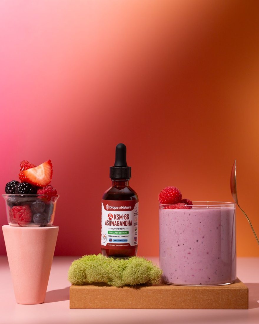 KSM-66 Ashwagandha drops beside a pink berry drink