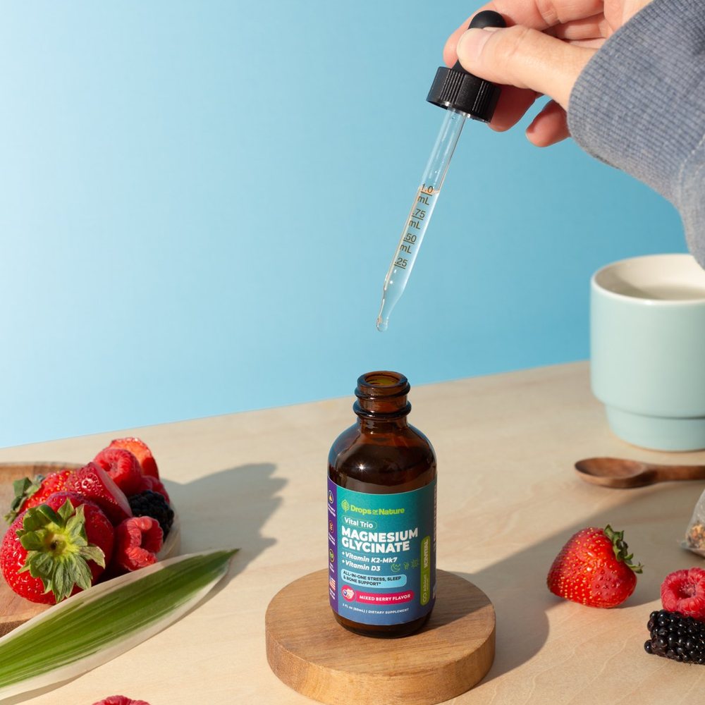 A dropper of Magnesium + D3 & K2 drops over its bottle.