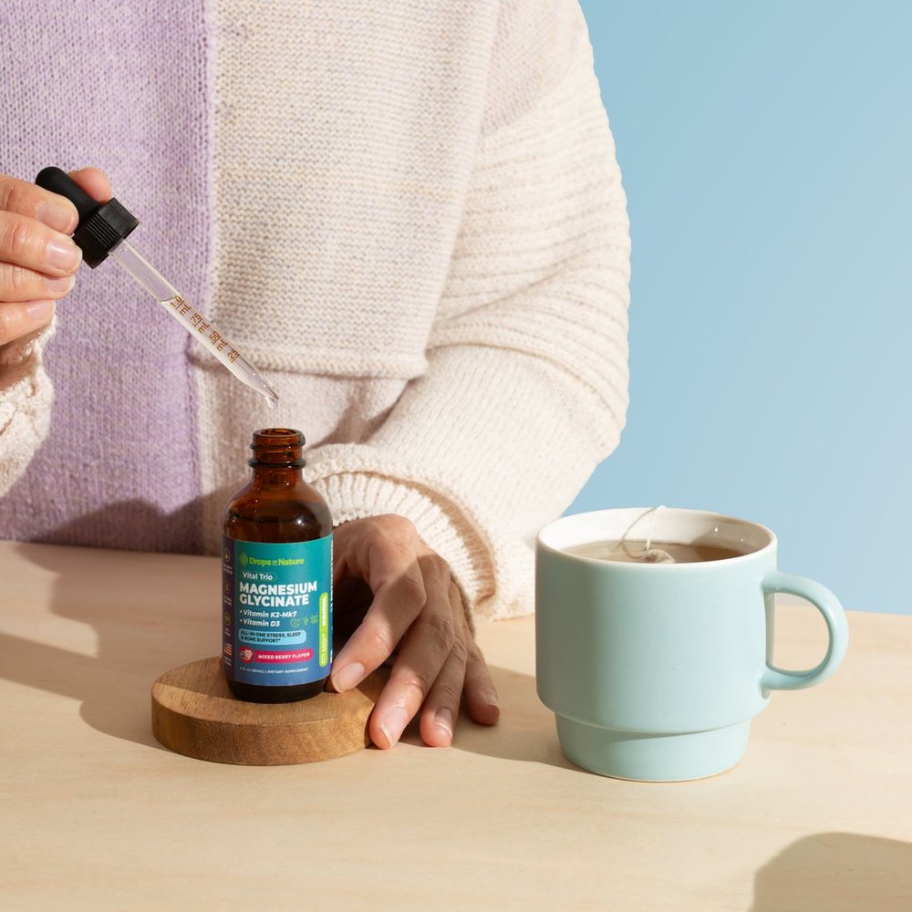 Magnesium + D3 & K2 drops going into a cup of tea.