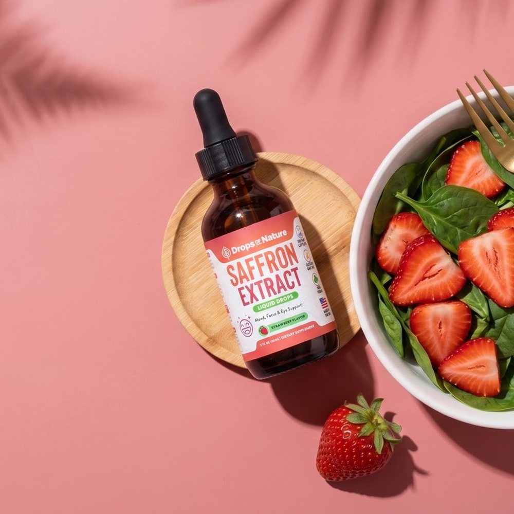 Saffron Extract bottle beside a strawberry salad.