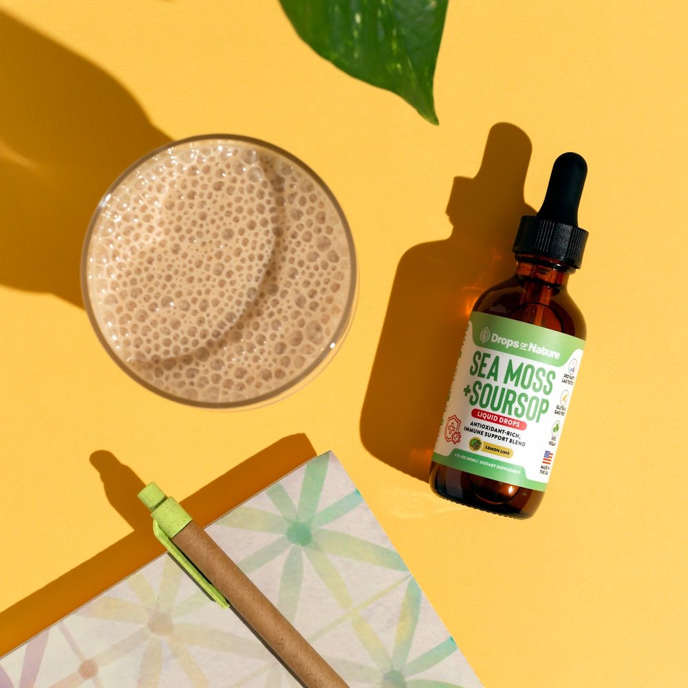Soursop + Sea Moss drops beside a smoothie.