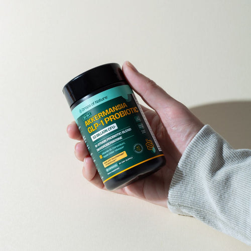 A hand holding a bottle of Akkermansia GLP-1 Probiotic.