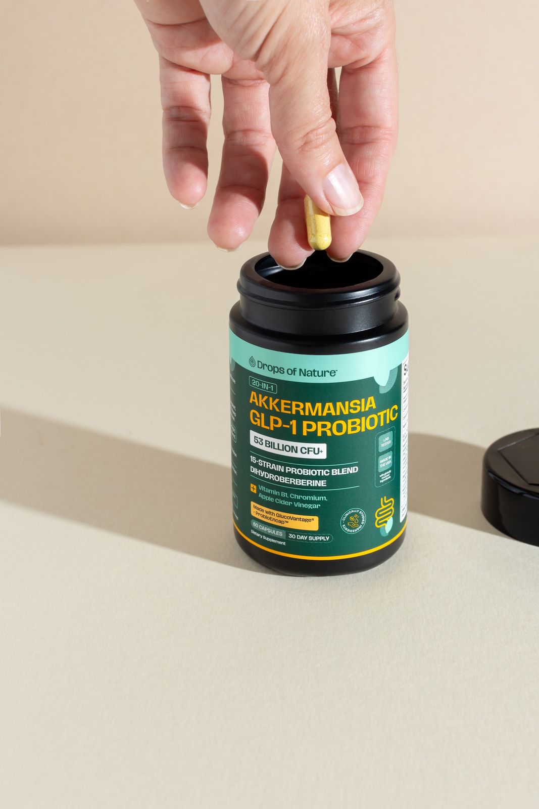 Hands holding a bottle of Akkermansia GLP-1 Probiotic.