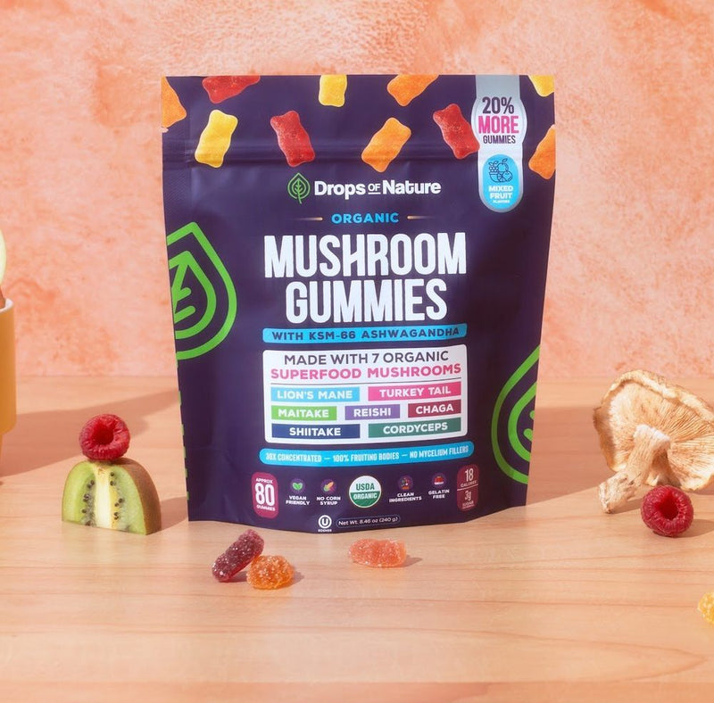 A bag of Drops of Nature Organic Mushroom Gummies with gummies on a wooden ledge