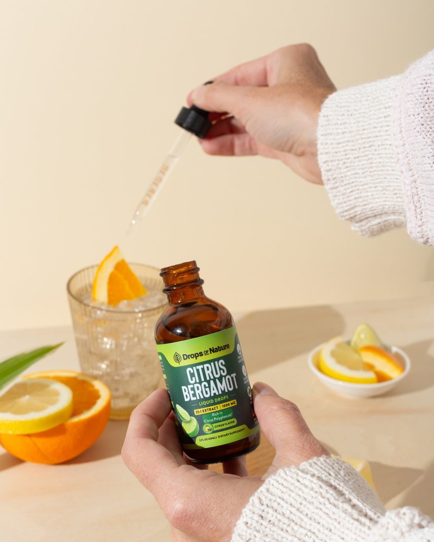 A dropper of Citrus Bergamot over a glass of water