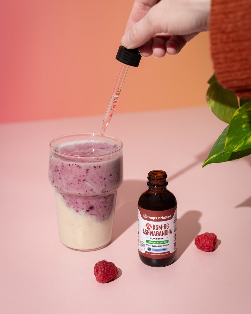 A dropper of KSM-66 Ashwagandha going into a pink smoothie