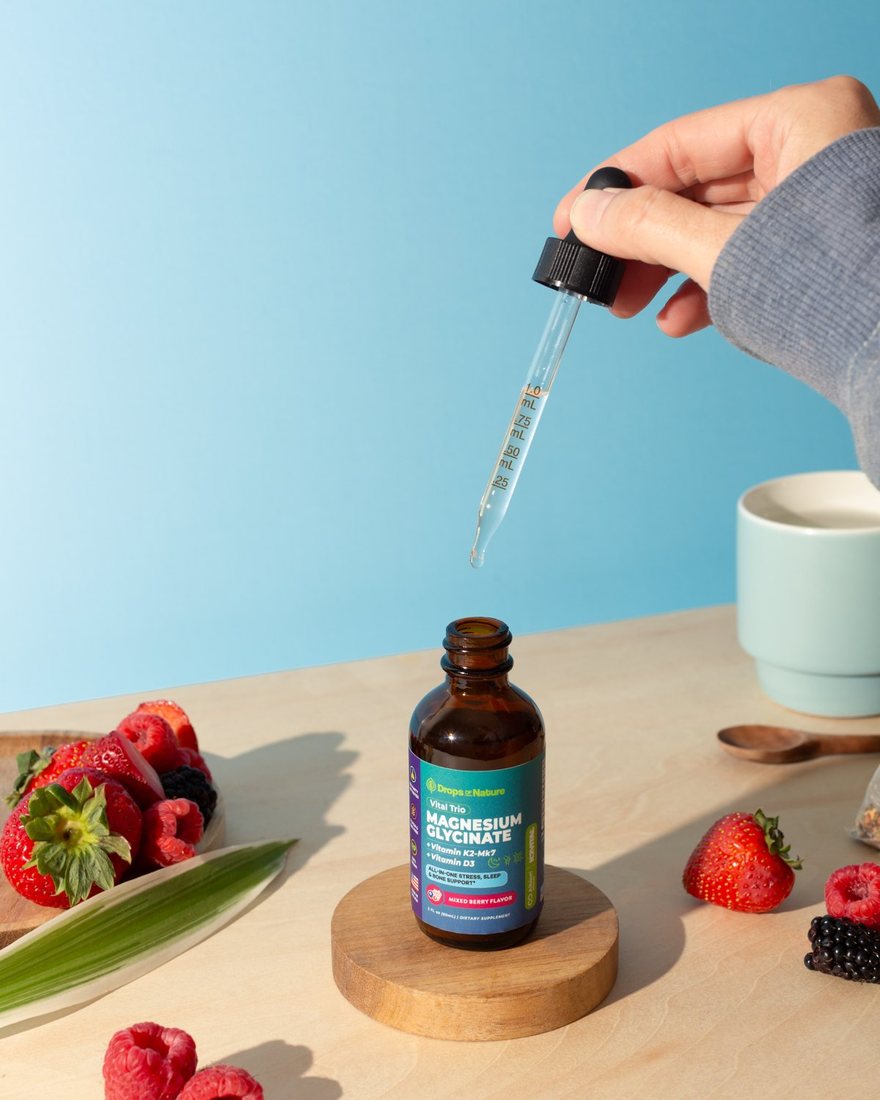 A dropper of Magnesium + D3 & K2 drops over its bottle