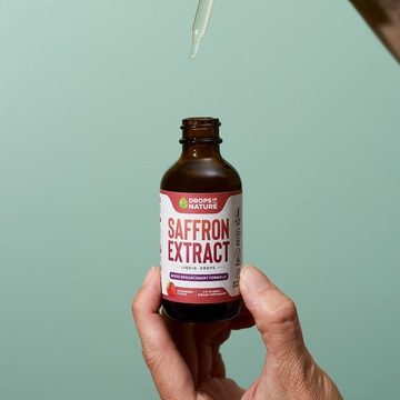 Saffron Drops bottle in hand